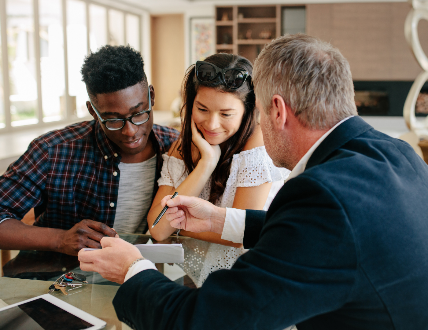 A loan originator discussing details with home buyers